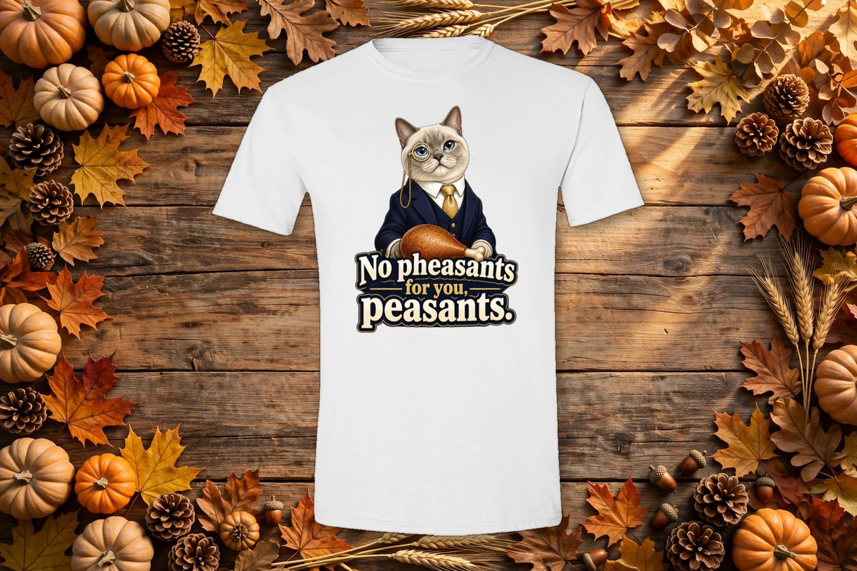 Styled flat lay of the No Pheasants for You, Peasants Thanksgiving cat t-shirt on a rustic autumn table