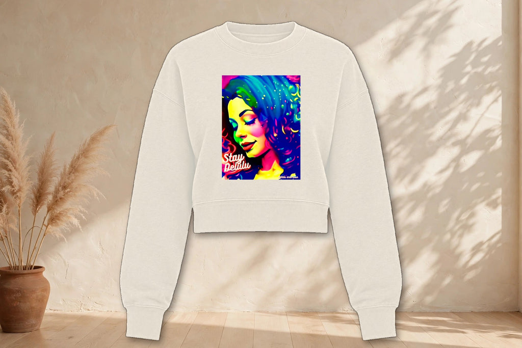 Stay Delulu pop art cropped sweatshirt in cream, styled in a boho studio setting